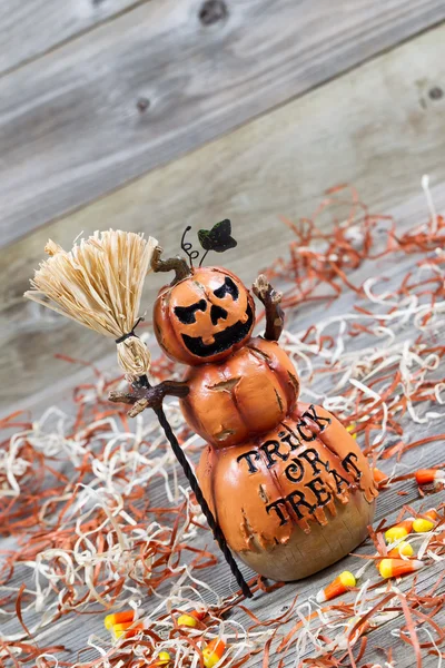 Scary large orange pumpkin ceramic figure on old wood — Stock Photo, Image