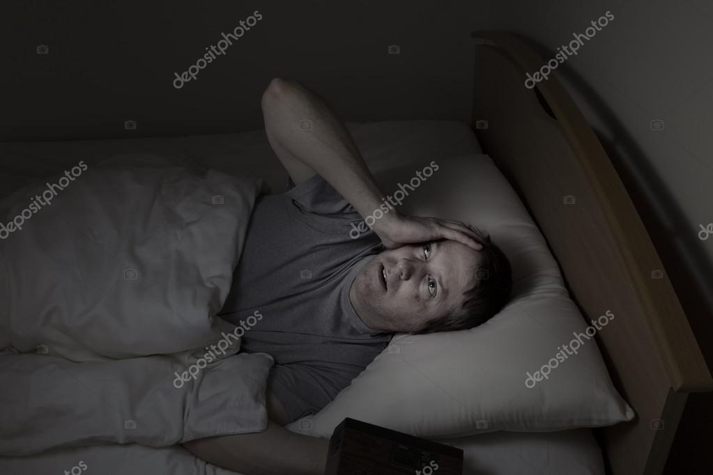 Mature Man Staring At Ceiling During Night Time While In Bed
