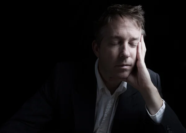 Depressed man resting his eyes — Stock Photo, Image