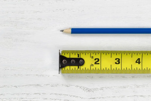 Tape Measure with sharpen pencil on wooden boards — Stock Photo, Image