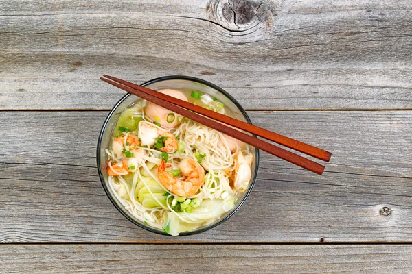 Spicy Chinese noodle soup in glass bowl — Stock Photo, Image