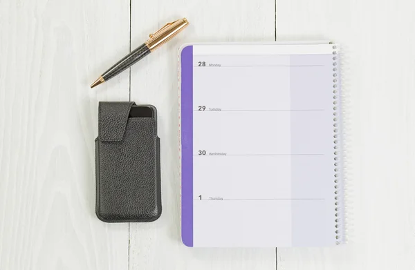 Top view of calendar with phone and pen on top of desktop — Stock Photo, Image