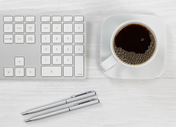 Cup of coffee on top of the office desktop — Stock Photo, Image