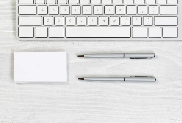 Stack of blank business cards and pens on white desktop — Stock Photo, Image