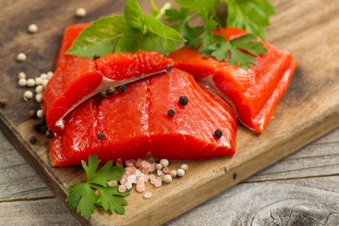 Fresh bright red Copper River Salmon fillets on rustic wooden se
