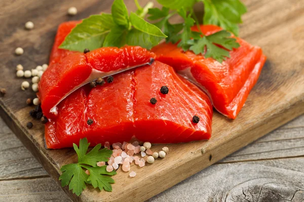 Fresh bright red Copper River Salmon fillets on rustic wooden se — Stockfoto