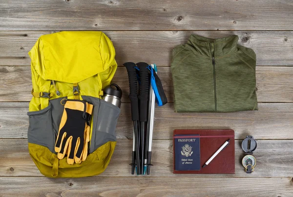 Backpack with walking accessories on rustic wooden boards — Stok fotoğraf