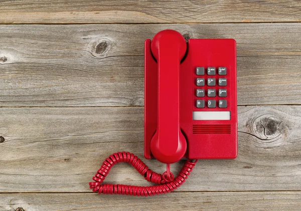 Vintage red phone on rustic wooden boards — 图库照片