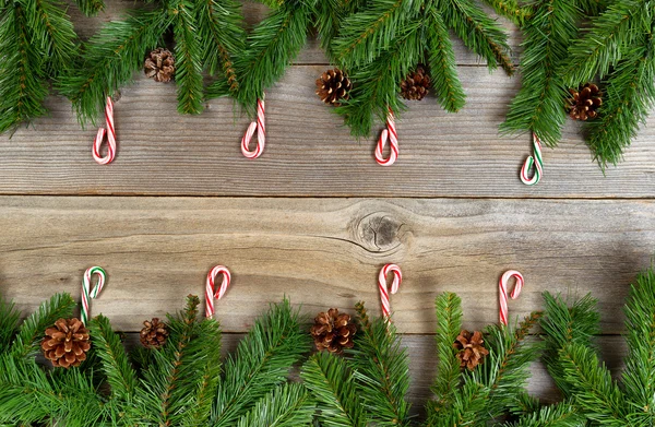 Christmas holiday border with evergreen branches and candy canes — Stock Photo, Image