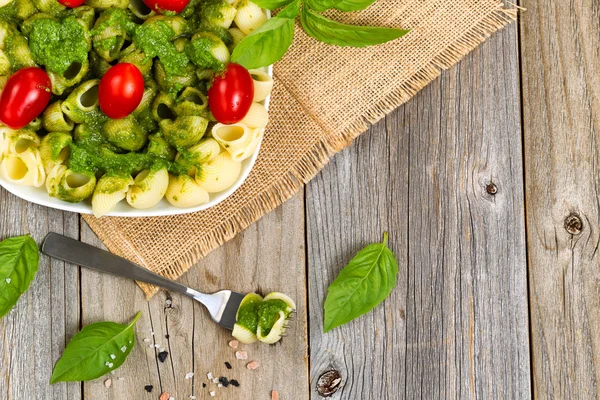 Frisches Basilikum-Pesto mit Kirschtomaten auf rustikalem Holz — Stockfoto