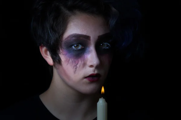 Girl in scary makeup with lite candle on black background — Stock Photo, Image