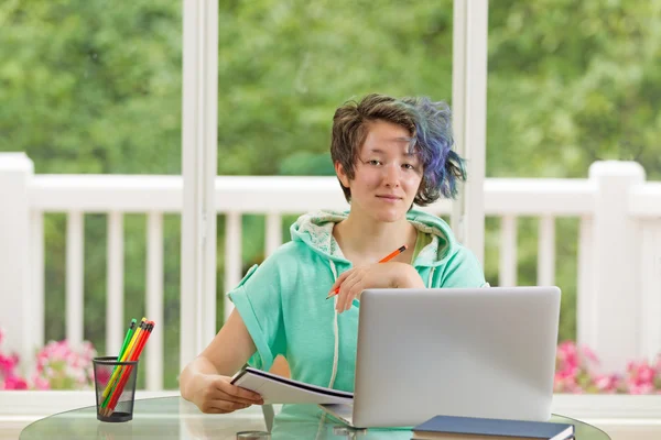 Relajada adolescente trabajando en sus estudios mientras está en casa —  Fotos de Stock