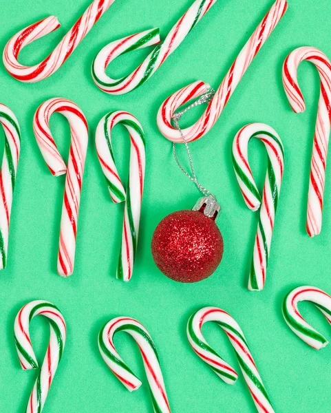 Collection of colorful candy canes and ornament on green backgro — Stock Photo, Image