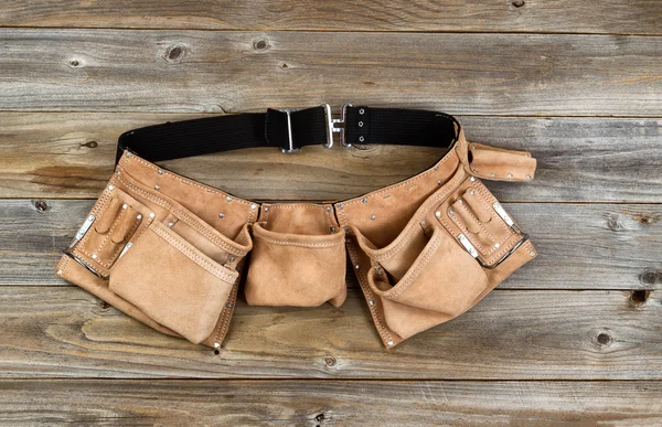 Leather tool belt on rustic wooden boards — Stock Photo, Image