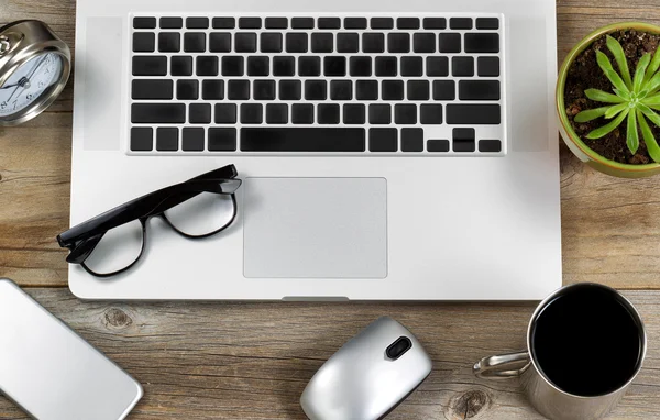 Mobile work setup on rustic wooden desk — Stock Photo, Image