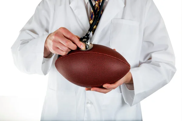 Medical doctor checking health of Football on white background — Stock Photo, Image