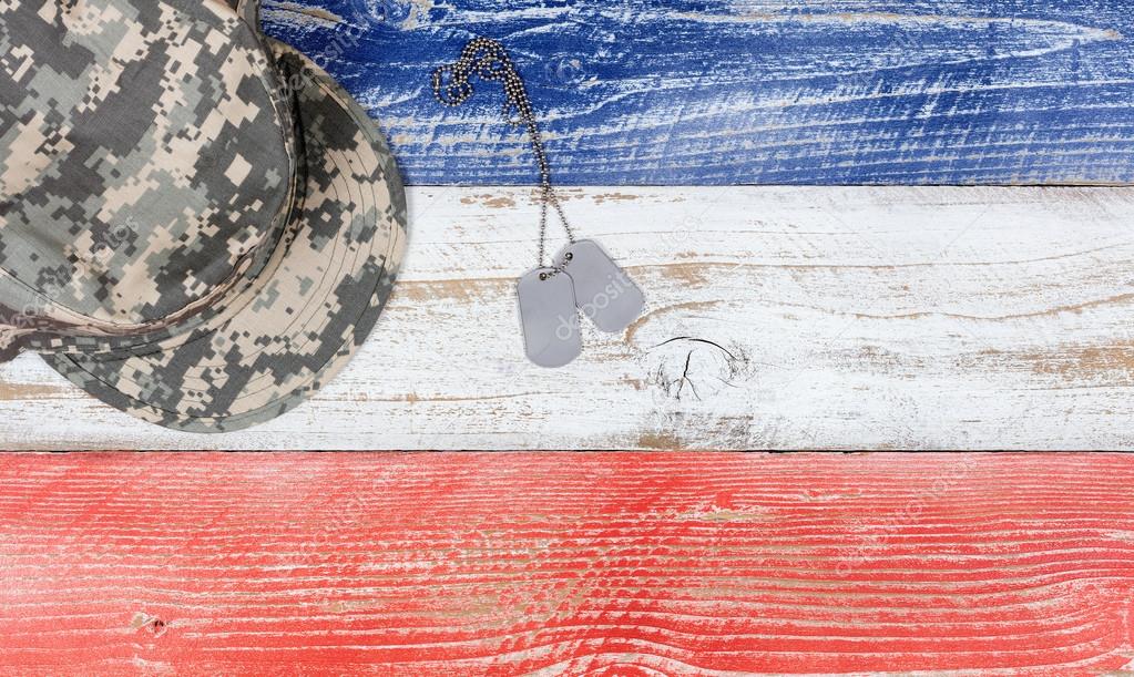 USA national colors with military cap and ID tags on wooden plan