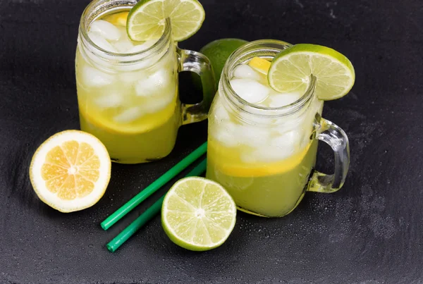 Homemade lemonade in jar glasses on black natural slate stone ba — Stock Photo, Image