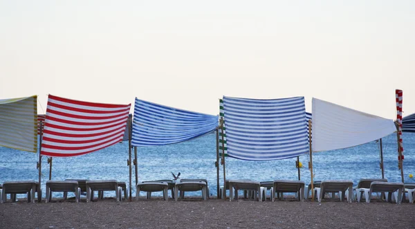 Dawn on beach with umbrellas — Stock Photo, Image