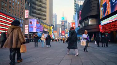 New York, ABD, 28 Aralık 2025: Times Square Pedestrians gündüz. Times Meydanı 'nda yürüyen yayalar Manhattan' da devasa dijital reklam panoları ve gökdelenlerle çevrili..