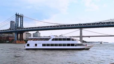 New York, ABD, 24 Ağustos 2025: Tur teknesi New York 'taki Manhattan Köprüsü altında seyahat ediyor.
