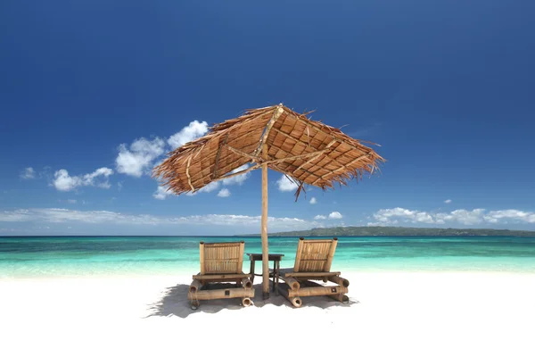 Stoelen met parasol op strand — Stockfoto