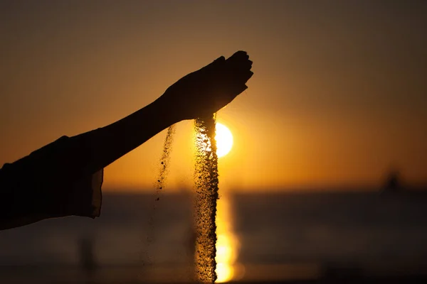 Silhuett Flickas Hand Häller Sand Från Strand Mot Gul Himmel — Stockfoto