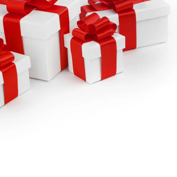 White gift boxes with red ribbons — Stock Photo, Image