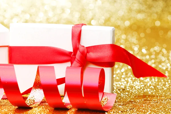 Белая коробка подарков с красной лентой — стоковое фото