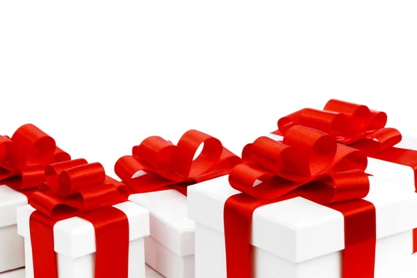 White gift boxes with red ribbons — Stock Photo, Image