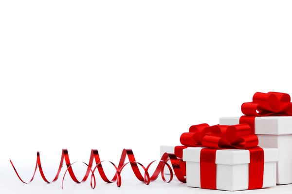 Gifts in white boxes with red ribbons — Stock Photo, Image