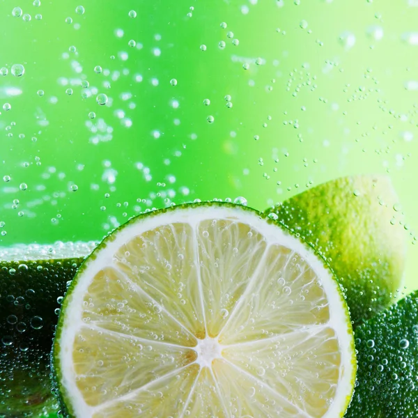 Limes in the water — Stock Photo, Image