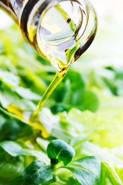 Pouring oil on corn salad — Stock Photo, Image