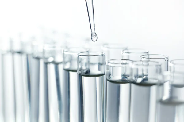 Pipette with drop of liquid — Stock Photo, Image