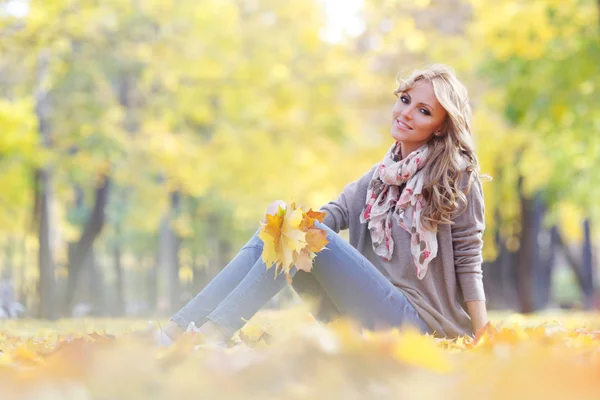 Femme assise dans le parc d'automne — Photo