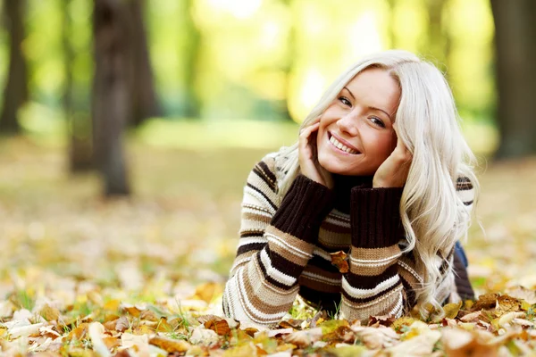 Woman on autumn leaves Stock Picture