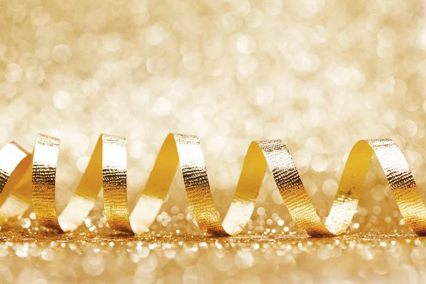 Shiny golden ribbon curls — Stock Photo, Image