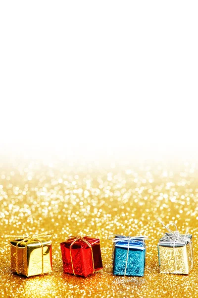 Small decorative colorful presents on glitter background — Stock Photo, Image