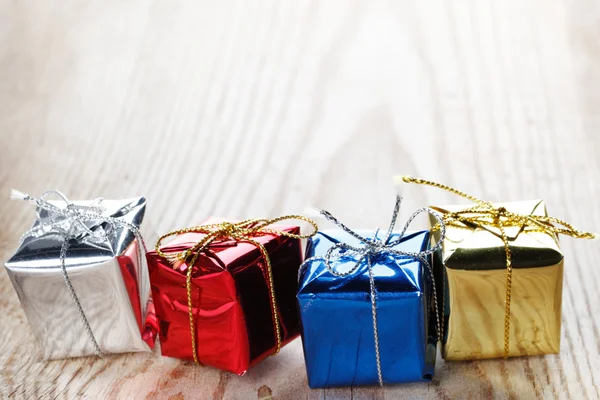 Small gift boxes on wooden background macro close-up — Stock Photo, Image