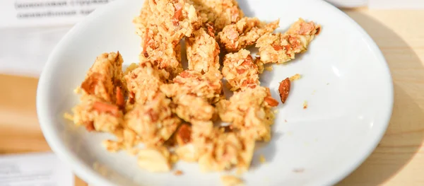 Sweet dessert with nuts on a white plate — Stock Photo, Image