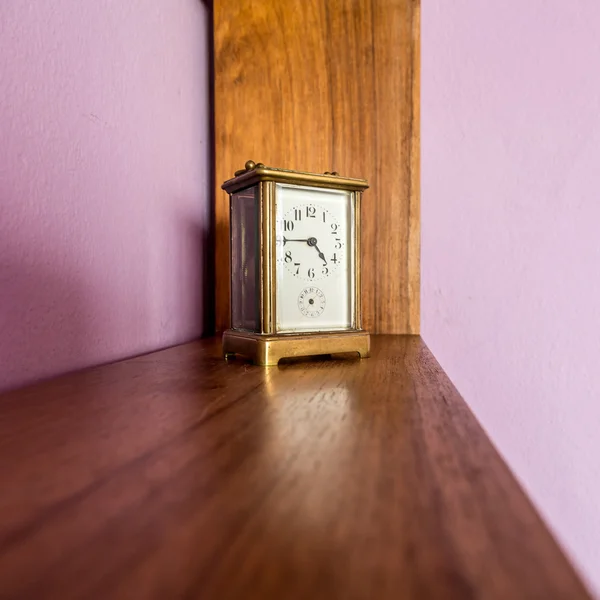 Old clock on a shelf — Stock Photo, Image