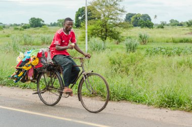 Street vendor riding his back full of merchandise 