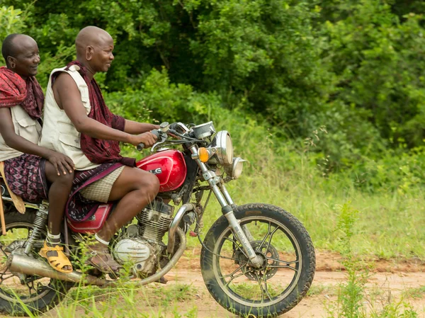 Maasai tribesmen riding a motorbike — ストック写真