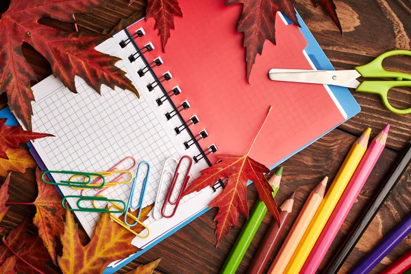 Notebook, pencils and autumn leaves — Stock Photo, Image
