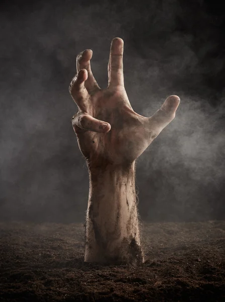 Hand climbs out of ground — Stock Photo, Image