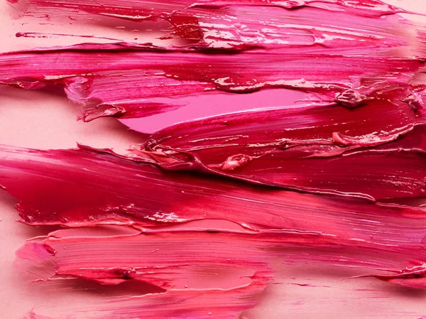 Lipstick smears over light pink background