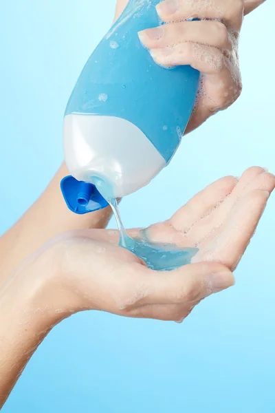 Bottle of shower gel in woman's hands — Stock Photo, Image