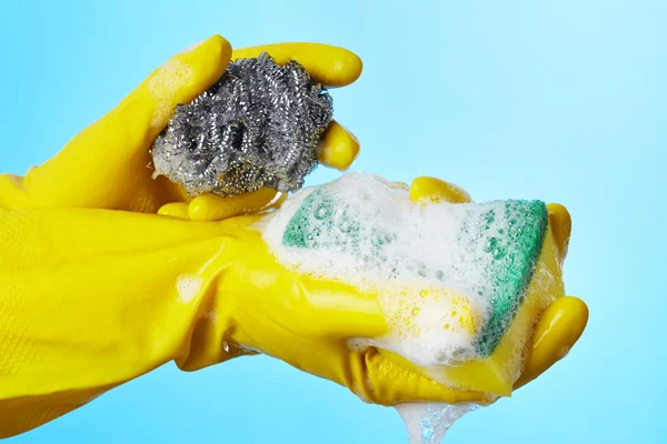 Woman's hands in gloves with sponge — Stock Photo, Image