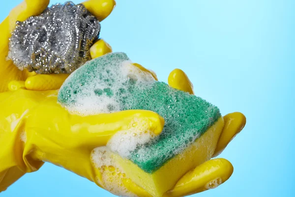 Woman's hands in gloves with sponge — Stock Photo, Image