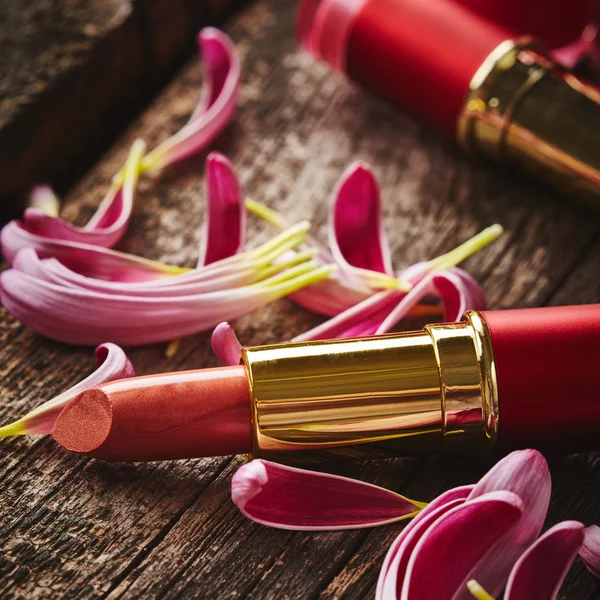 Lipstick with flower petals — Stock Photo, Image